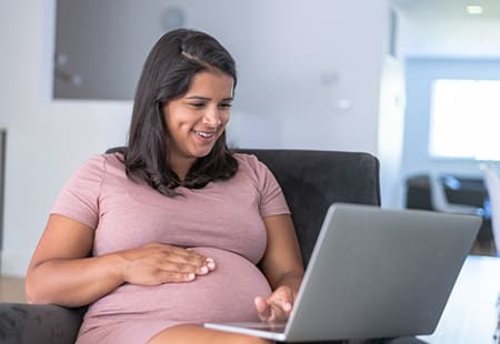 Ethnic Pregnant Woman Working From Home Breastfeeding Success -Pregnancy Support Group