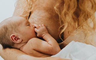 red-haired woman with inverted nipples breastfeeding her baby