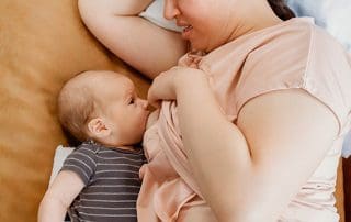 woman breastfeeding with mastitis and clogged milk ducts