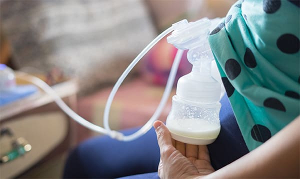 woman using a breast pump at work